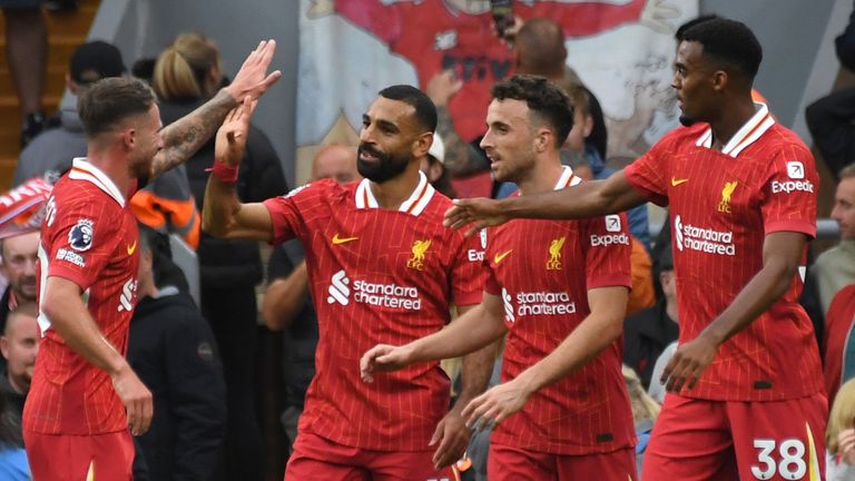 Liverpool's Mohamed Salah, centre, celebrates with teammates after scoring his side's second goal during the English Premier League soccer match between Liverpool and Brentford at Anfield Stadium, Liverpool, England, Sunday, Aug. 25, 2024. (AP Photo/Rui Vieira)