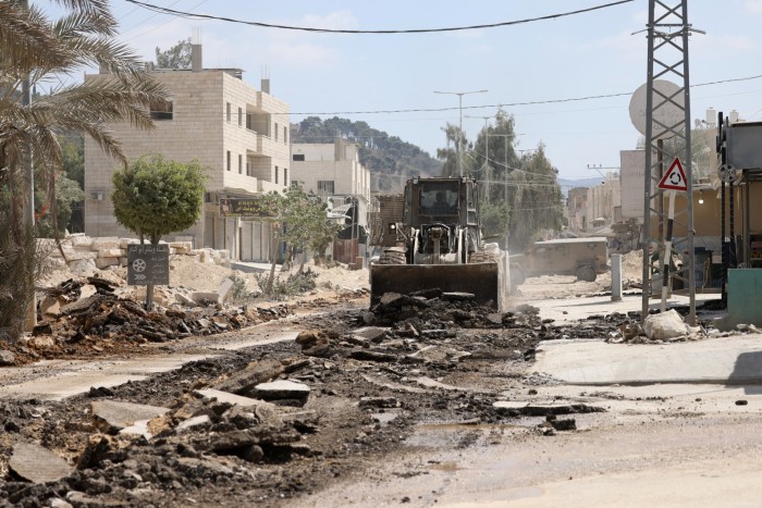 An Israeli military bulldozer destroys a road during a raid in the Nur Shams camp for Palestinian refugees near the city of Tulkarem in the Israeli-occupied West Bank