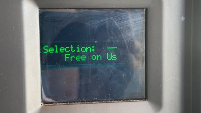 Text reads, Selection: free on us, on the outside of a harm reduction vending machine. 