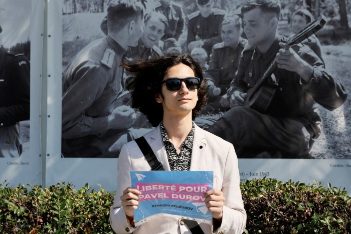 A person demonstrates with a placard to bring attention to the arrest of Pavel Durov