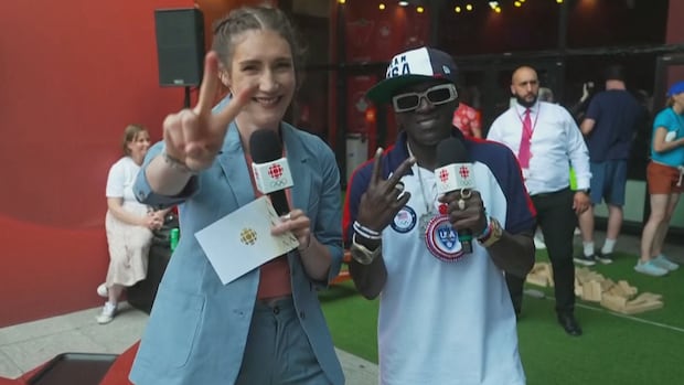 CBC Sports' Anastasia Bucsis and American rapper Flavor Flav pose for the camera in Paris on August 2, 2024.