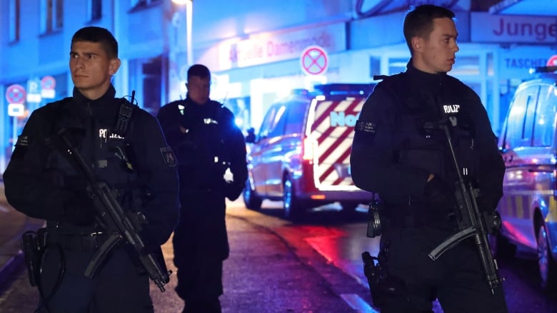 Police officers are seen near the scene of a deadly attack that occurred at a festival in Solingen, Germany, on Friday.