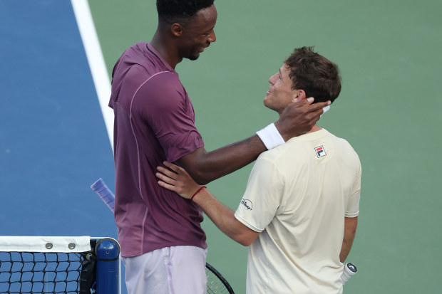 Gael Monfils of France talks with Diego Schwartzman of Argentina after their US Open clash.