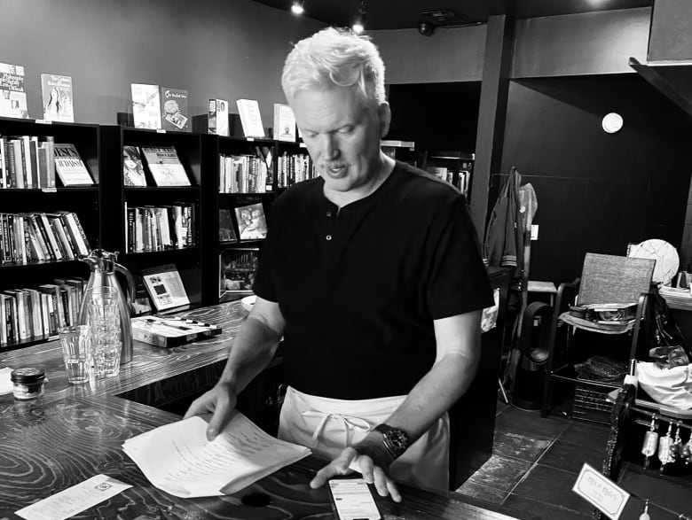 A person looks at a desk inside what appears to be a book store.