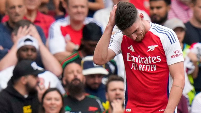 Arsenal's Declan Rice leaves the pitch after being shown a red card (AP Photo/Alastair Grant)