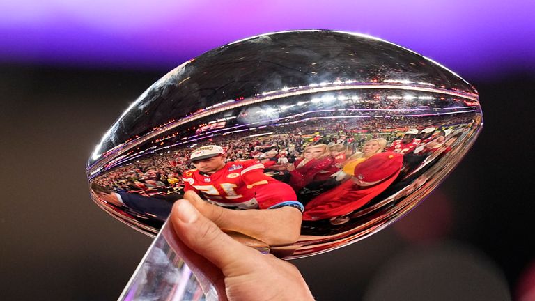 Kansas City Chiefs quarterback Patrick Mahomes is reflected in the Vince Lombardi Trophy after the NFL Super Bowl 58 football game against the San Francisco 49ers, Sunday, Feb. 11, 2024, in Las Vegas.