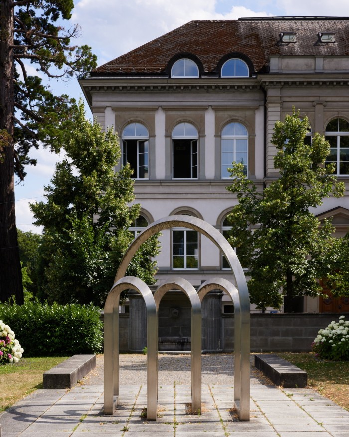 Markus Feldmann’s silver arched sculpture, its shapes mirroring the arches of the neoclassical university building behind it