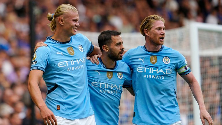 Manchester City's Erling Haaland celebrates with Bernardo Silva and Kevin De Bruyne after scoring his side's opening goal (AP Photo/Dave Shopland)