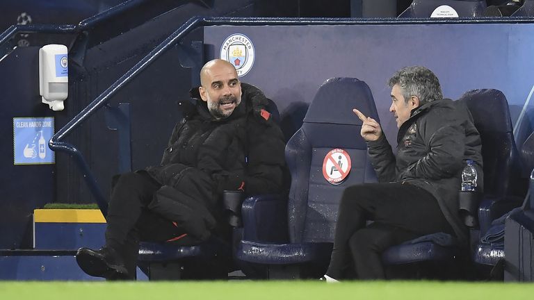 Manchester City manager Pep Guardiola (left) speaks with assistant Juan Manuel Lillo in the dugout during the Champions League match against Marseille at the Etihad Stadium, Manchester in 2020