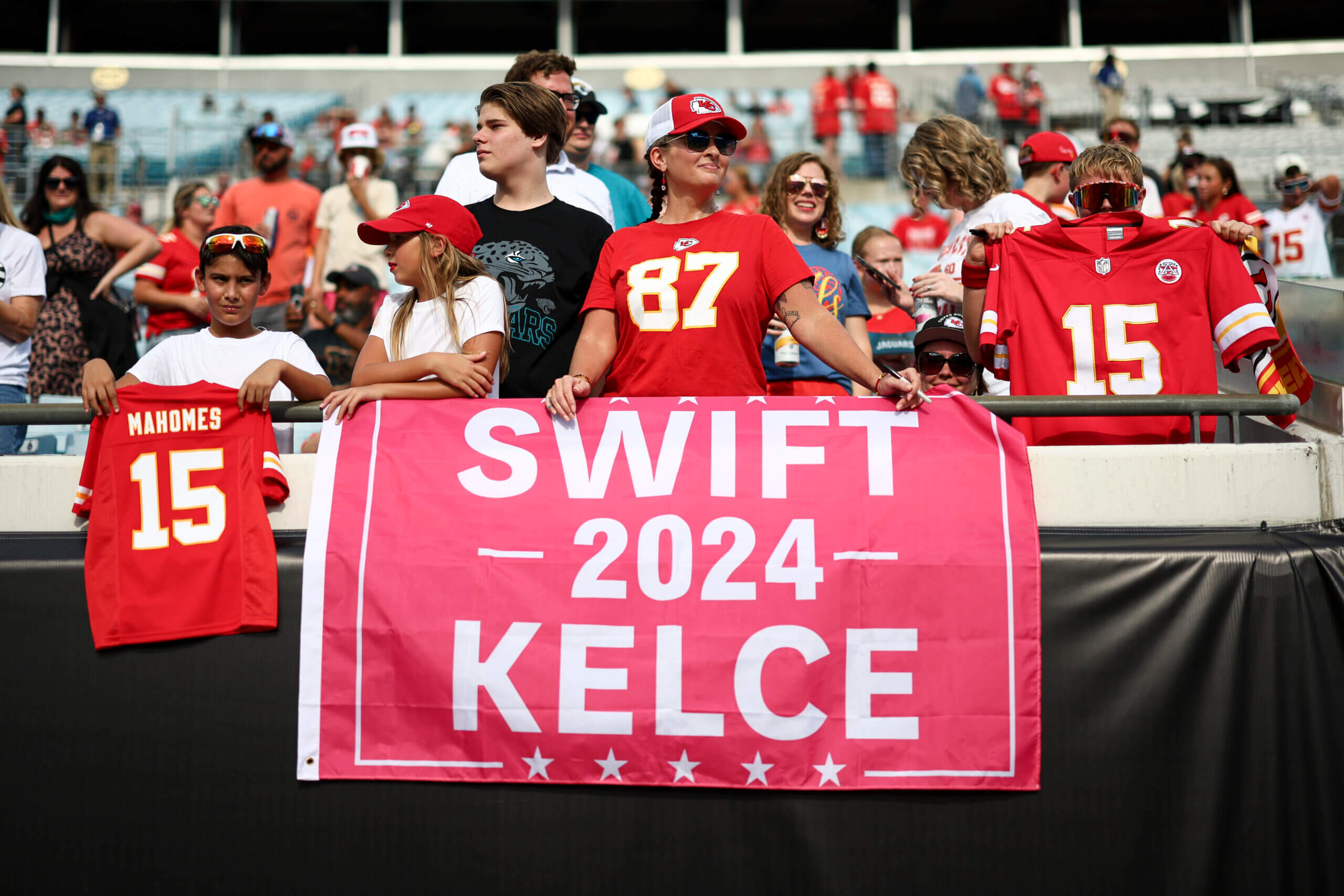 A Kansas City Chiefs fan holds a campaign sign for Taylor Swift and Travis Kelce in the stands prior to an NFL preseason football game against the Jacksonville Jaguars at EverBank Stadium on August 10, 2024 in Jacksonville, Florida.