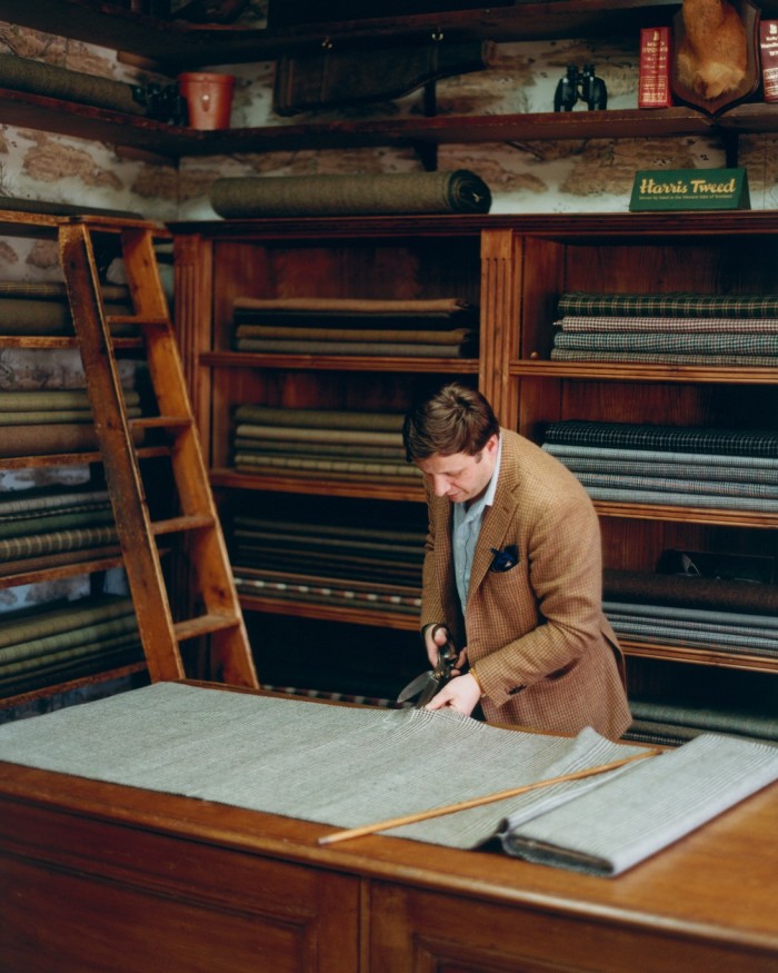 John Sugden, owner of Campbell’s, cuts tweed in the cutting room