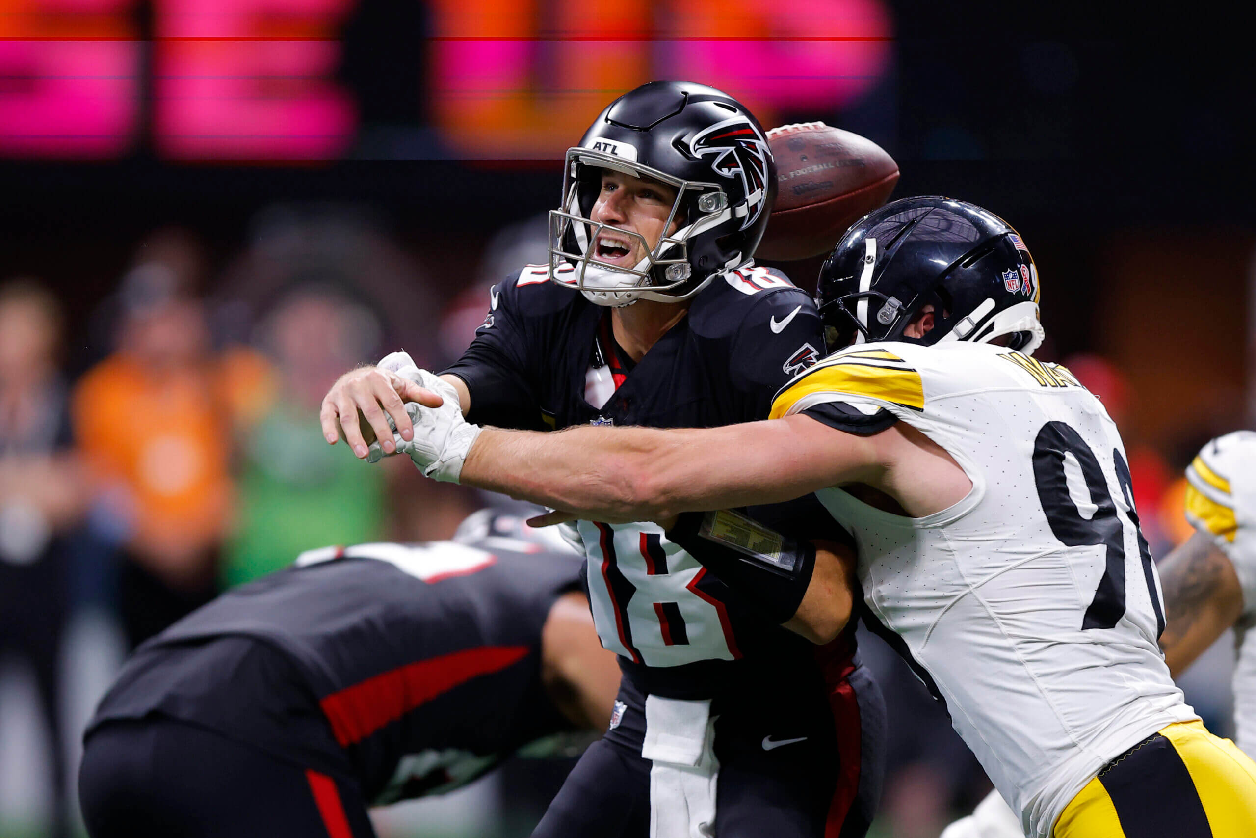 T.J. Watt of the Pittsburgh Steelers hits Kirk Cousins of the Atlanta Falcons while Cousins' attempts a pass during the third quarter at Mercedes-Benz Stadium on September 08, 2024 in Atlanta, Georgia.