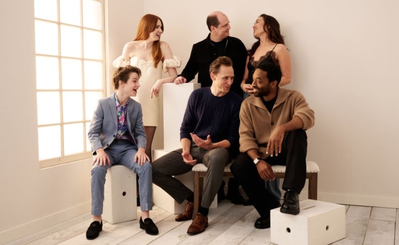 Actors sit for a photo.