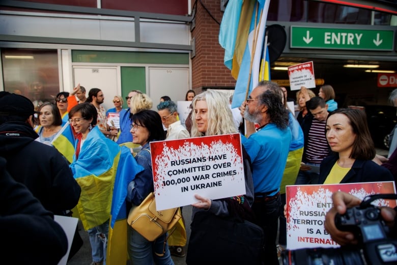 Crowd of protesters in front of a theatre protesting the film Russians at War.