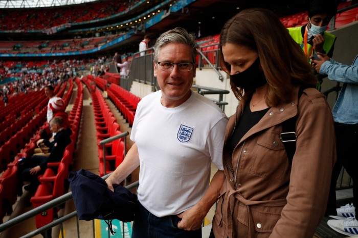 The pair are walking down steps at the stadium