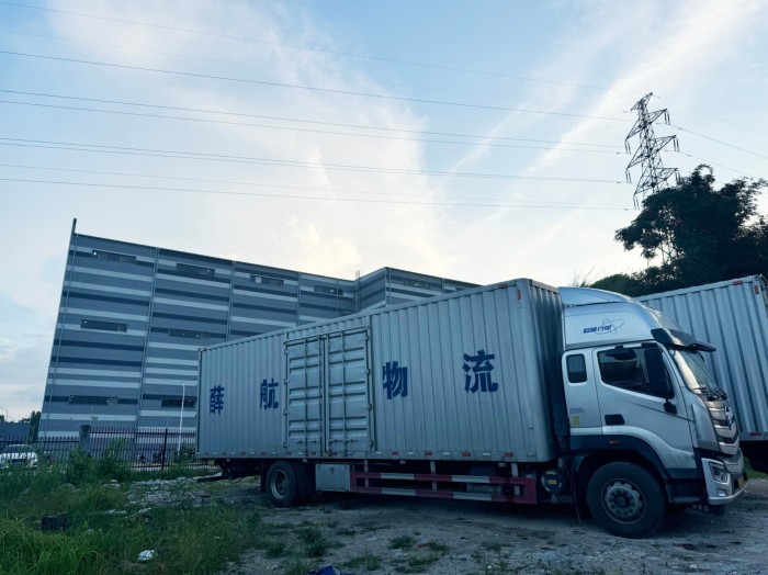 A lorry parked outside a warehouse