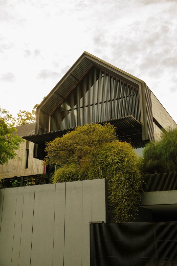 A two-storey modern house with a pitched roof, seen from one side