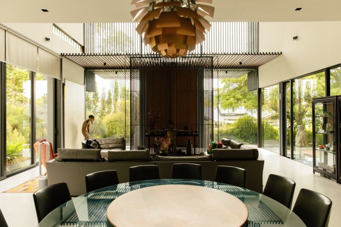 A large round glass-rimmed dining table, with wooden chairs around