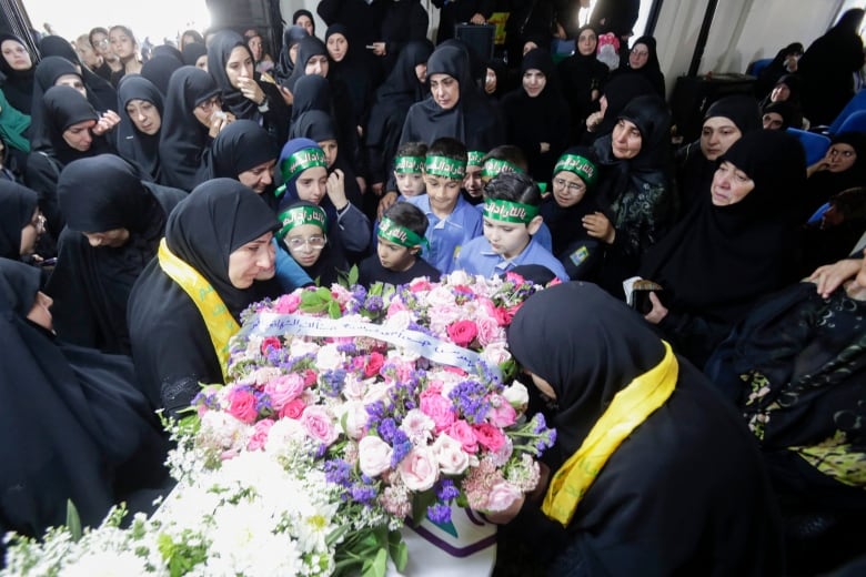 Mourners surround the coffin of a 10-year-old girl who was killed in explosions in Lebanon on Sept. 17, 2024.