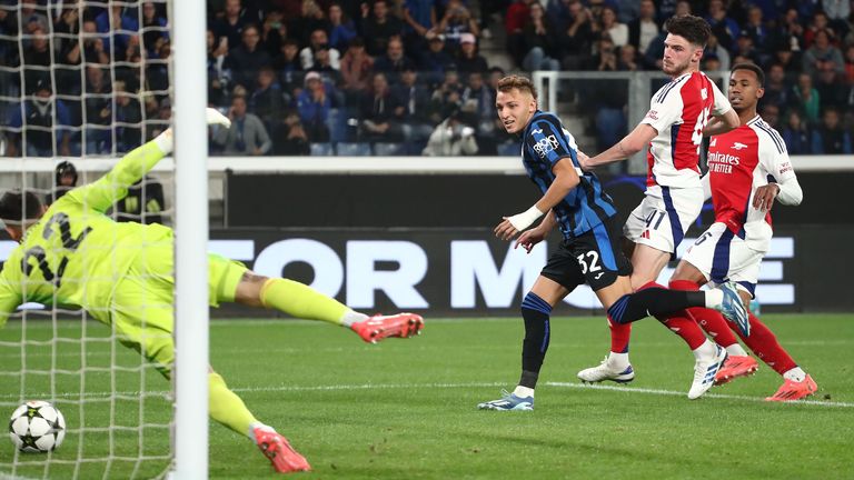 Arsenal's David Raya gets up to save Mateo Retegui's follow-up shot  for Atalanta after the penalty