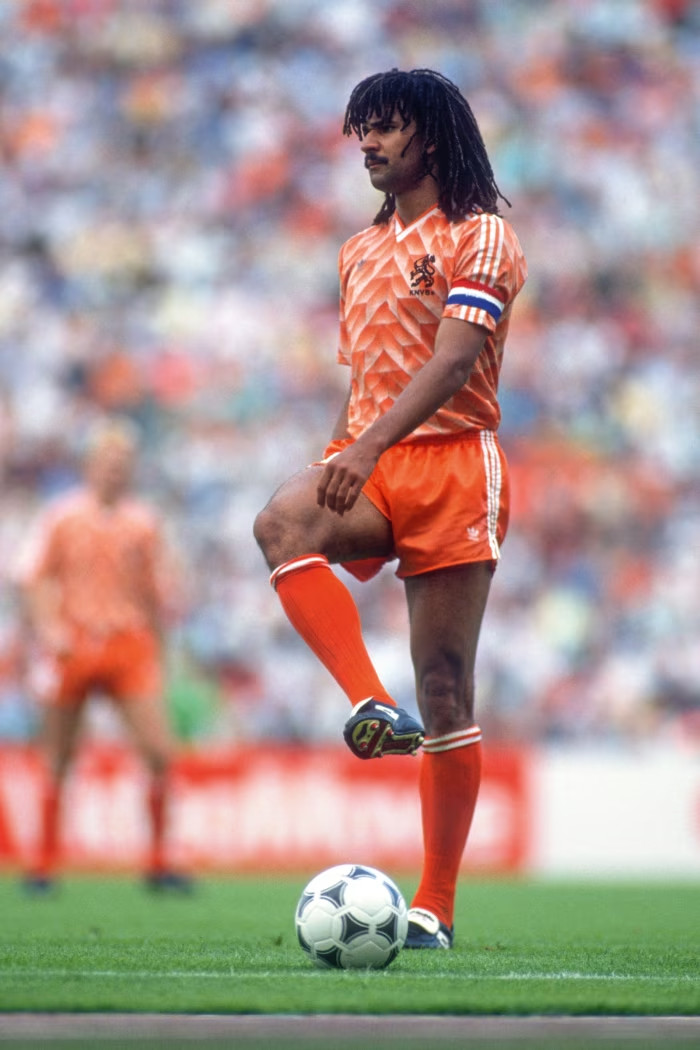 Ruud Gullit of the Netherlands during a football match, wearing  a geometric-patterned, orange shirt