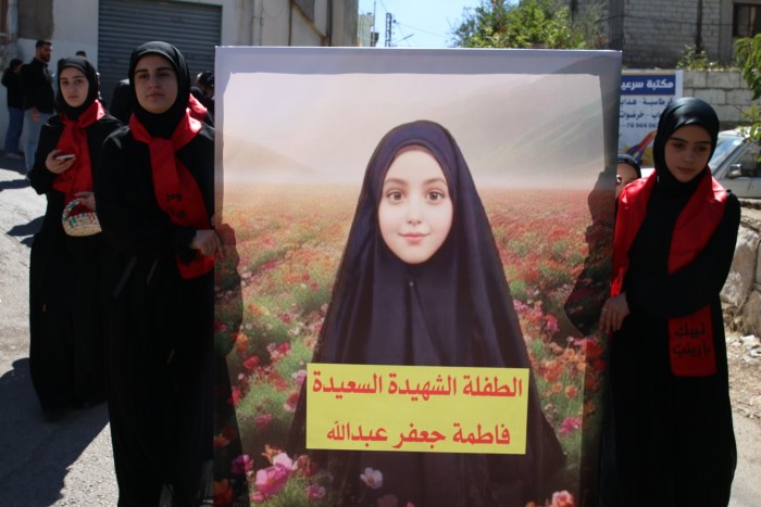 People attend the funeral ceremony held for Fatima Abdullah