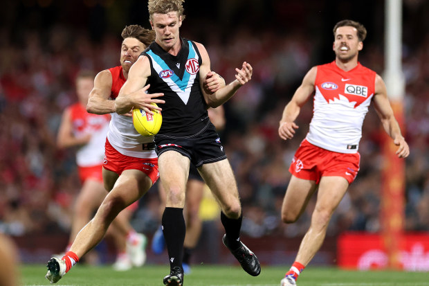 Jason Horne-Francis kicks whilst being tackled by Dane Rampe.