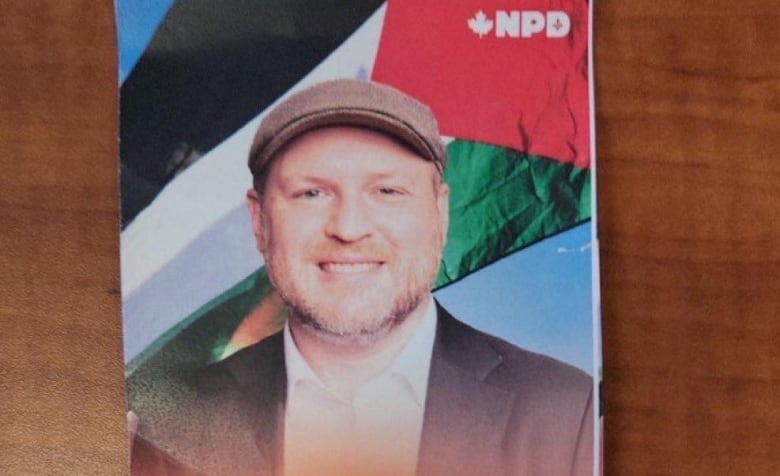 NDP Candidate Craig Sauvé's campaign pamphlet depicts him standing in front of a Palestinian flag. 