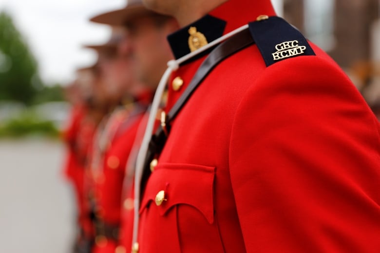 A line of Mounties in red serge.