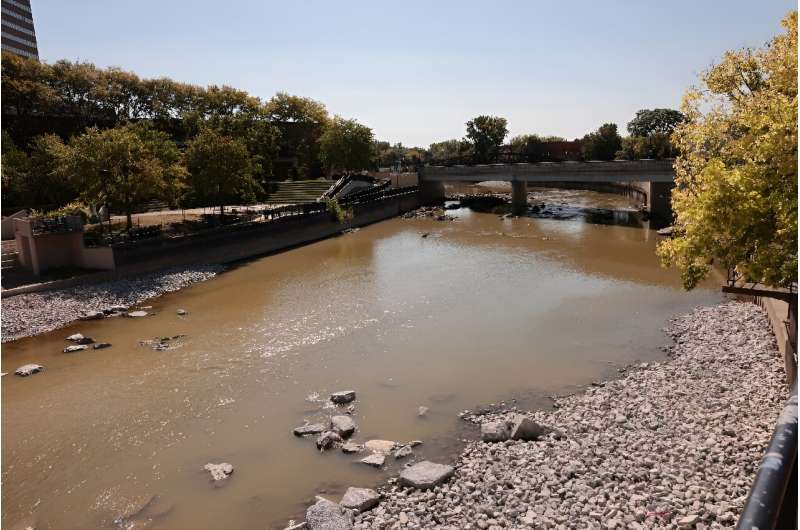 A river crosses Flint, where ten years on residents still bathe in bottle water and refuse to drink from the tap