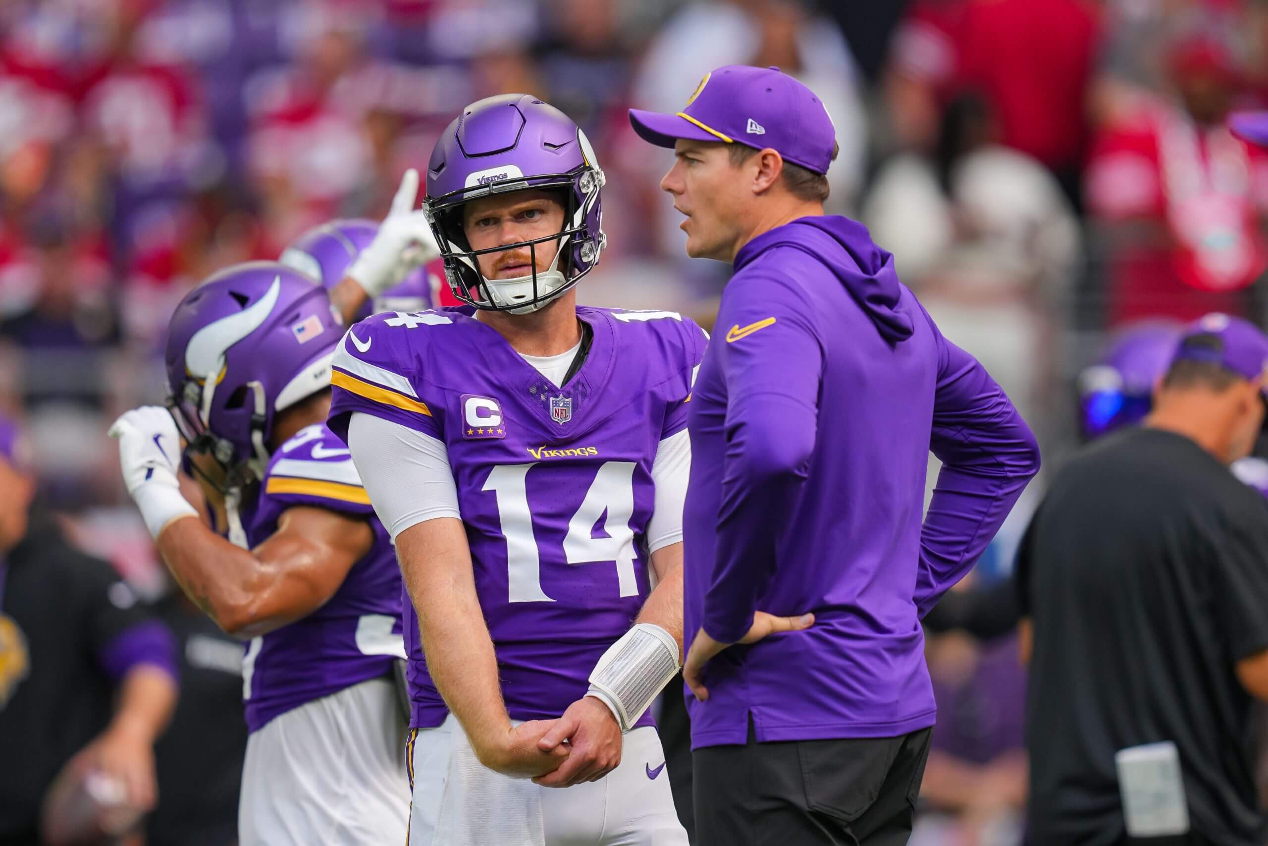 Minnesota Vikings quarterback Sam Darnold and head coach Kevin O'Connell talk before the game against the San Francisco 49ers at U.S. Bank Stadium.