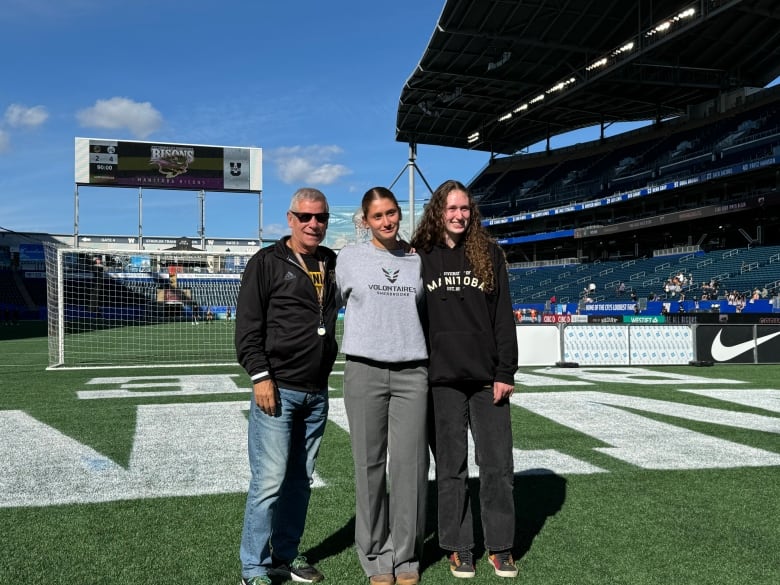 University of Manitoba Bison men's football head coach Brian Dobie, Amélie Beauregard and Maya Turner at the stadium shared by the Bisons and the CFL's Winnipeg Blue Bombers.