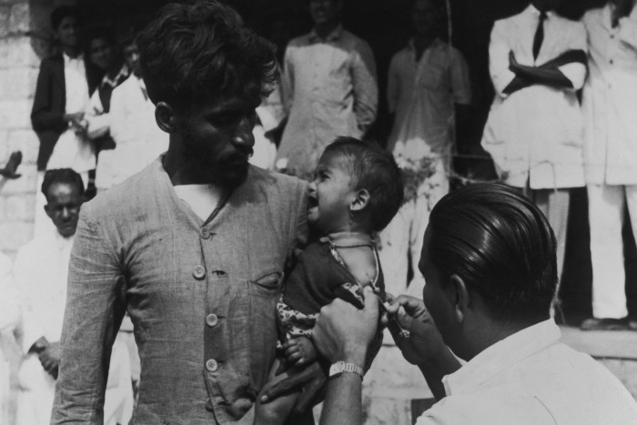 A baby girl receives her BCG vaccination against tuberculosis at a United Nations-funded clinic in Pakistan, circa 1950.