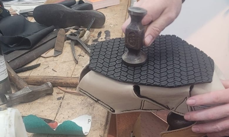 Rubber treads being put onto a shoe.