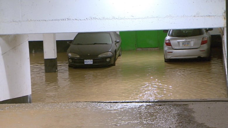 Two cars in flooded underground parking lot