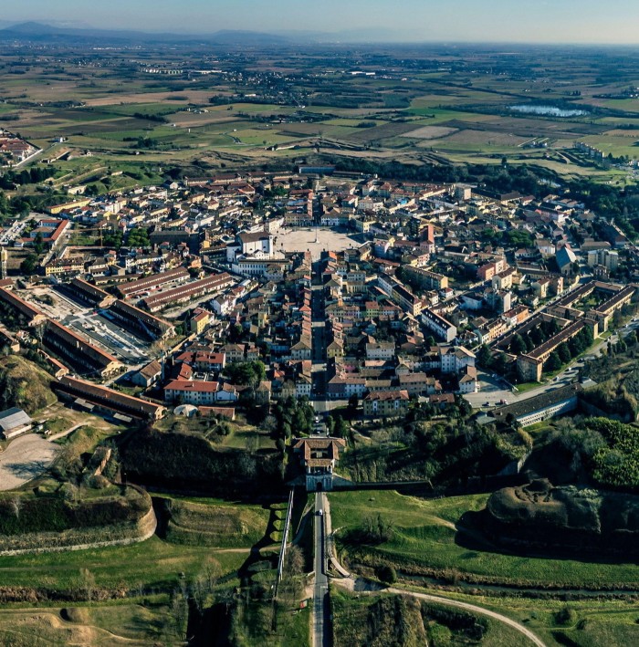 An aerial view of a city planned in a star-like shape with streets radiating outwards in concentric rings