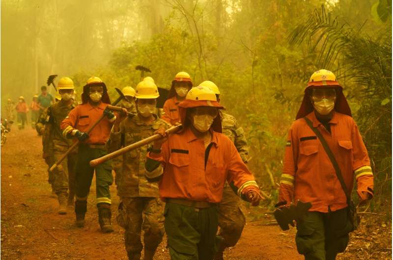 Firefighters arrive at the scene of a fire in Concepcion,  Boliva, on September 24, 2024