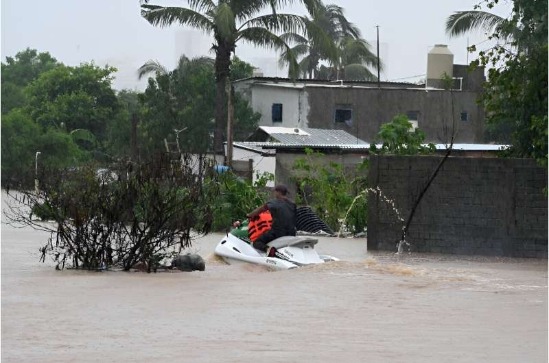 A man rides a jet ski in a flooded area of Mexico's Acapulco