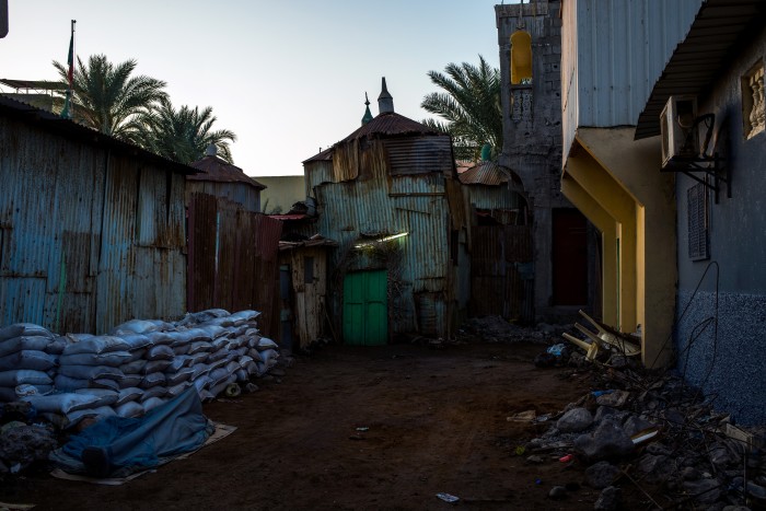 A green door leads to a tin mosque