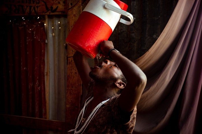 A man drinks from a flask 