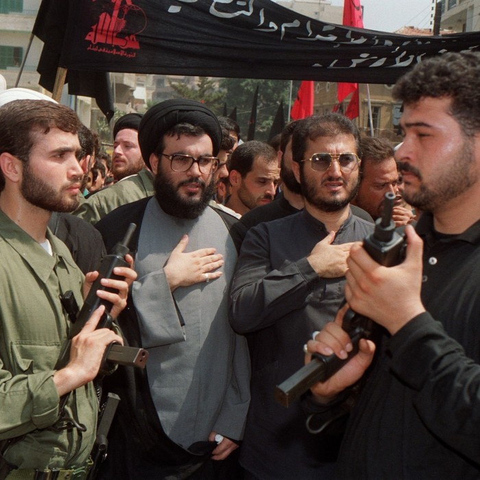 Hassan Nasrallah surrounded by bodyguards in a Beirut suburb in 1992