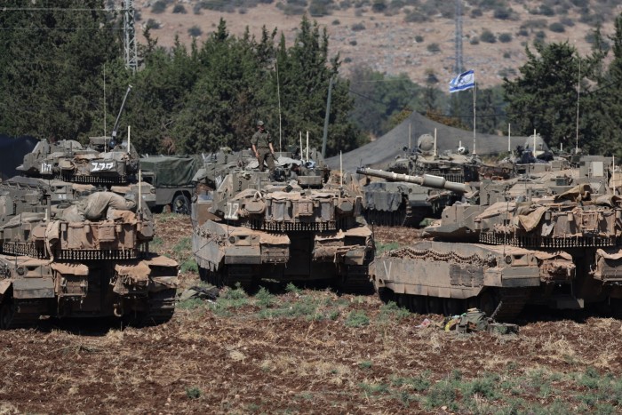 Israeli soldiers with their tanks gather in northern Israel