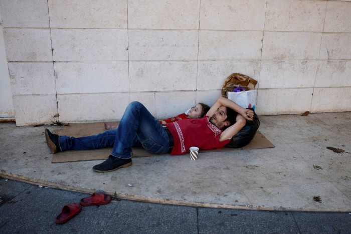 A displaced family sleeps near Beirut’s central Martyrs’ Square after fleeing the overnight Israeli strikes in southern Beirut, in Lebanon