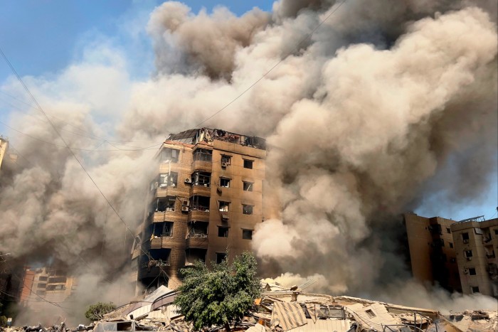 Smoke rises as a building collapses in Beirut’s southern suburbs, Saturday, Sept. 28, 2024.