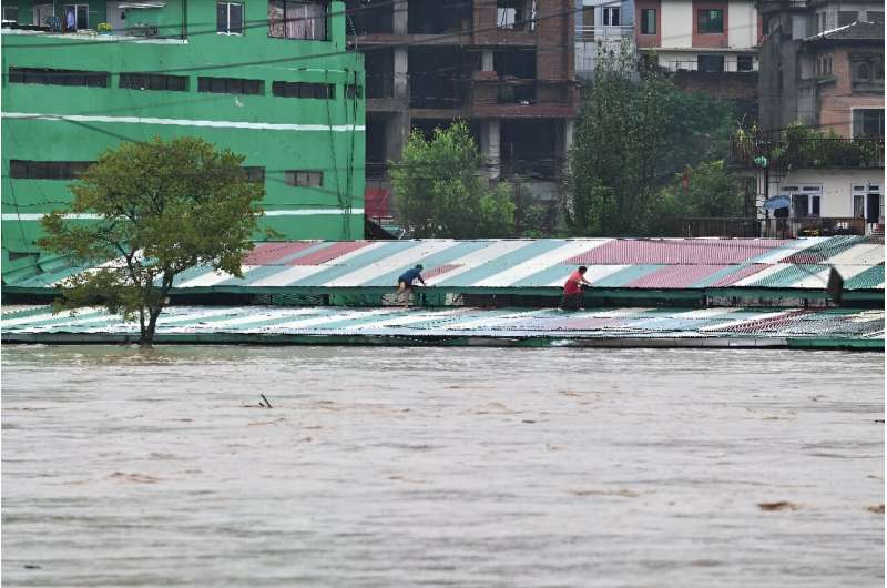 Areas of Kathmandu were flooded after the Bagmati River overflowed. Floods and landslides have killed at least 59 people across Nepal