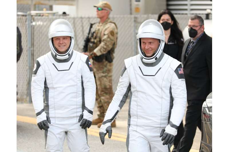 US astronaut Nick Hague (R) and Russian cosmonaut Alexander Gorbunov head to a Kennedy Space Center launch pad in Florida