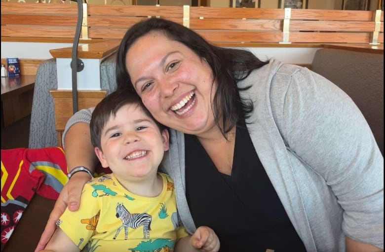 A smiling mother and child in a restaurant