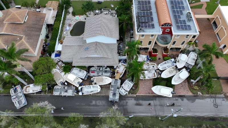 Boats are stacked up in front of homes after Hurricane Helene hit the area as it passed offshore on September 28, 2024 in Treasure Island, Florida