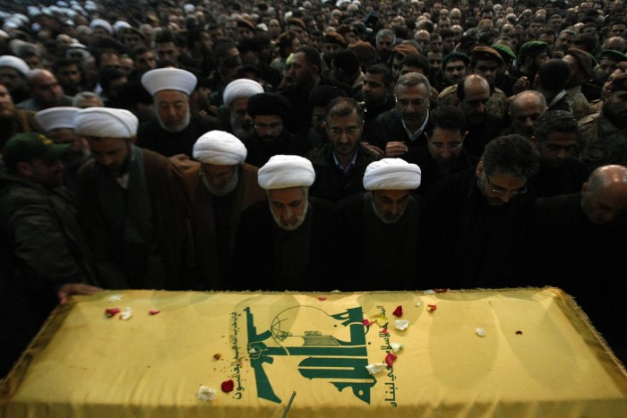 Mourners pray over the coffin of an assassinated Hizbollah commander in Beirut in 2008