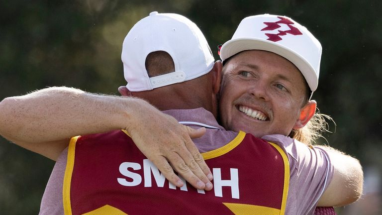 Captain Cameron Smith, right, of Ripper GC embraces caddie Sam Pinfold, left, on the 18th green after Ripper GC won the final round of LIV Golf Team Championship Dallas at Maridoe Golf Club, Sunday, Sept. 22, 2024, in Carrollton, Texas. (Katelyn Mulcahy/LIV Golf via AP)